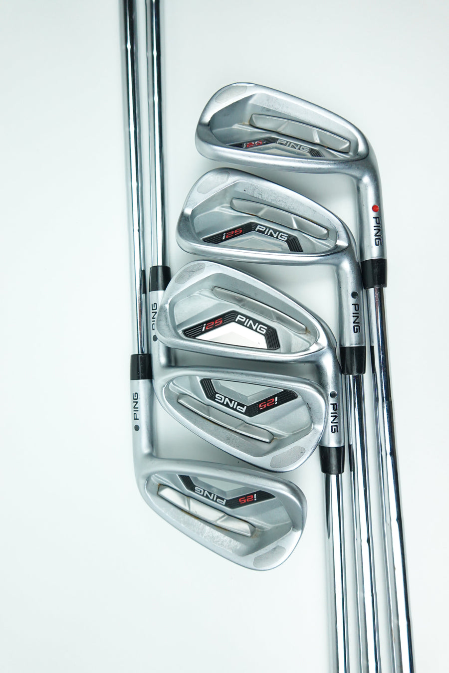Five PING iron golf clubs arranged in a fan shape on a clean white background, showing the clubheads and part of the shafts.