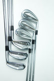 A set of eight golf iron clubs arranged diagonally on a clean white background, showcasing their polished silver metal heads and black grip accents.