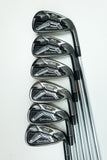 Six TaylorMade Axiom golf iron clubs arranged in a diagonal row on a clean white background.