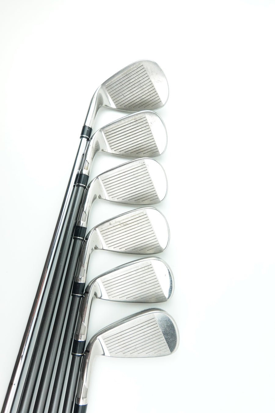 A set of seven golf iron clubs arranged in a fan shape on a plain white background.